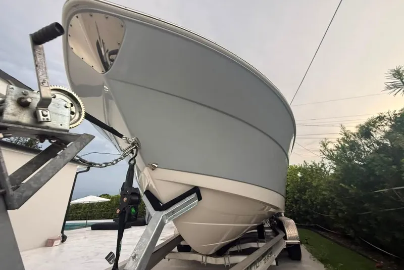 Slide: The Image of 2020 Robalo R222 Explorer boat on trailer, viewed from below, showcasing sleek hull design. - 22