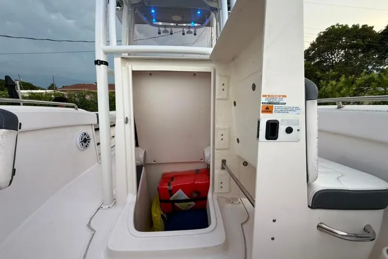 Slide: The Image of 2020 Robalo R222 Explorer boat storage compartment with safety equipment inside. - 24