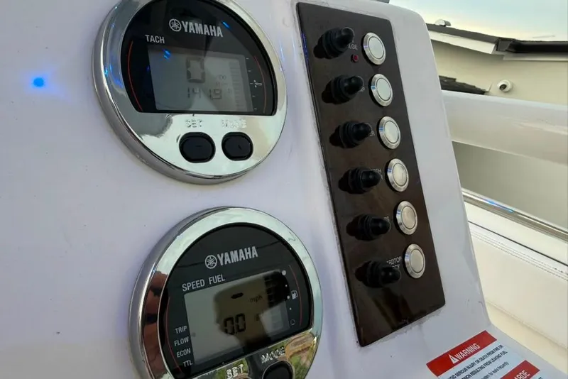 Slide: The Image of Yamaha gauges and controls on a 2020 Robalo R222 Explorer boat dashboard. - 30