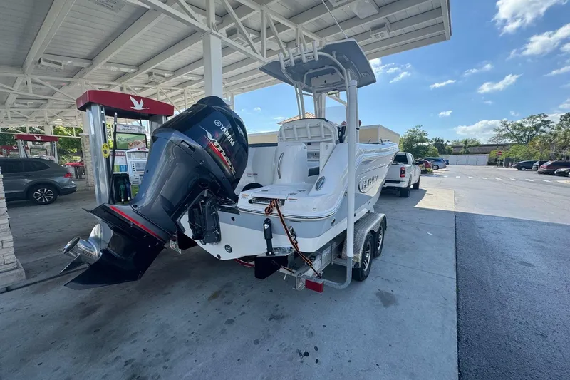 Slide: The Image of 2021 Robalo R222 Center Console boat on trailer at gas station. - 32
