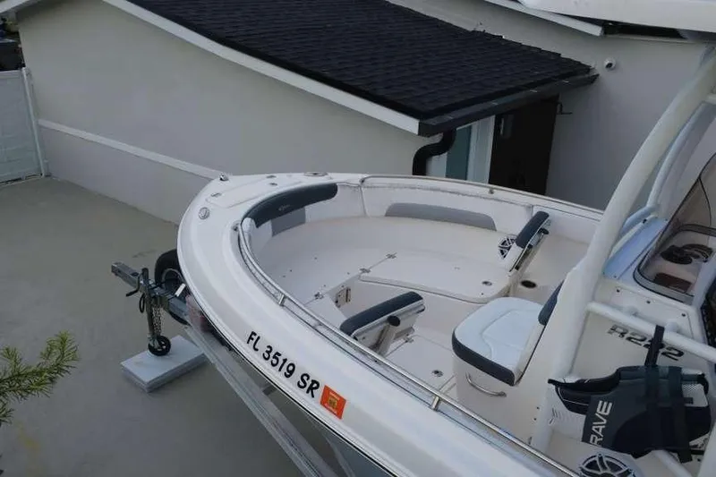Slide: The Image of 2020 Robalo R222 Explorer boat parked on a driveway near a house. - 4