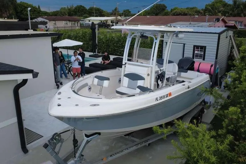 Slide: The Image of 2020 Robalo R222 Explorer boat on trailer in residential driveway setting. - 8