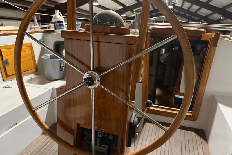 Slide: The Image of Wooden steering wheel of a 1978 CSY 44 Center Cockpit sailboat, showcasing nautical craftsmanship. - 14