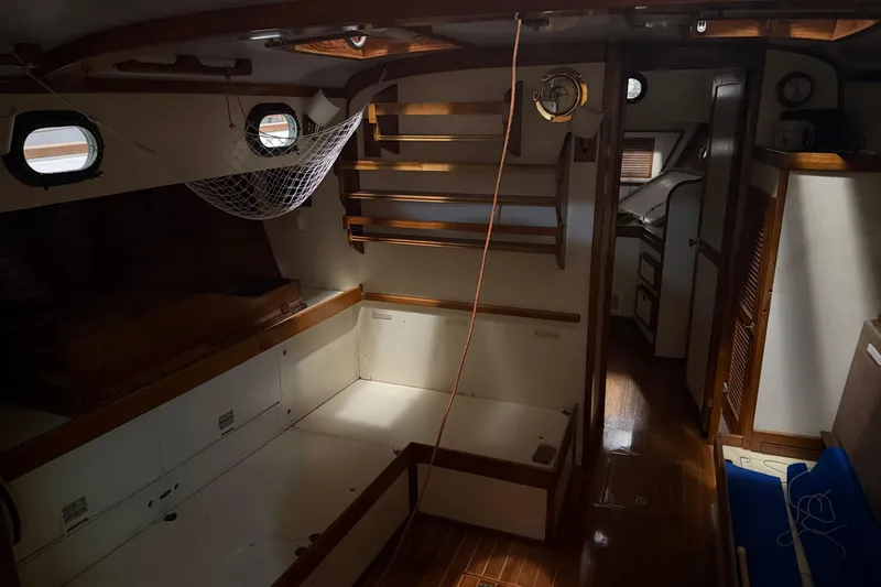 Slide: The Image of Interior of a 1978 CSY 44 Center Cockpit sailboat with wooden finishes and netting. - 16