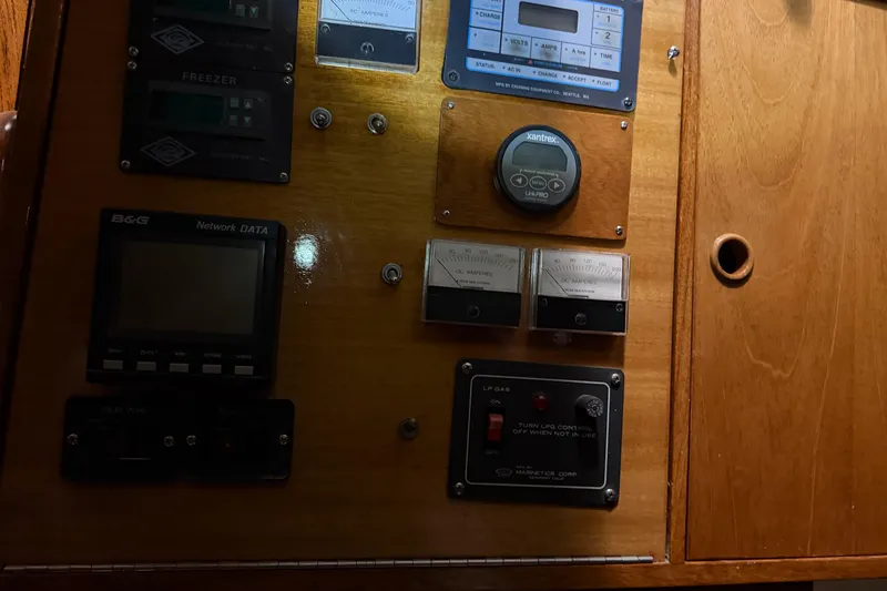 Slide: The Image of Control panel of a 1978 CSY 44 Center Cockpit sailboat with various gauges and switches. - 18