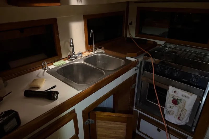 Slide: The Image of 1978 CSY 44 Center Cockpit galley with dual sinks and stove. - 19