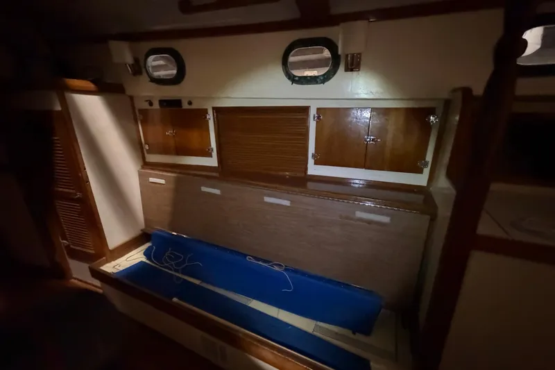 Slide: The Image of 1978 CSY 44 Center Cockpit interior with wooden cabinets and portholes. - 20