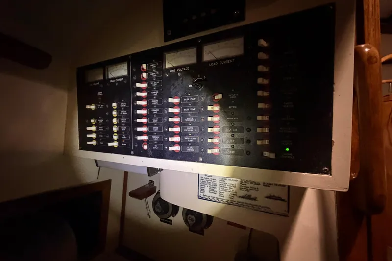 Slide: The Image of Electrical panel of a 1978 CSY 44 Center Cockpit sailboat, featuring switches and gauges. - 25
