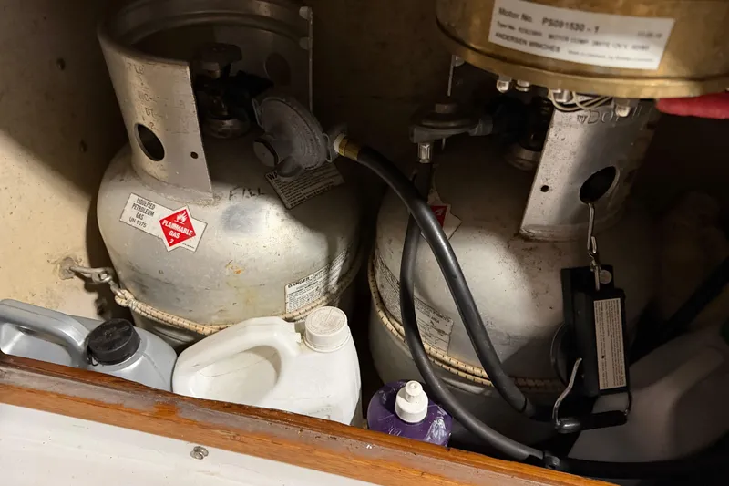 Slide: The Image of Propane tanks and cleaning supplies in a 1978 CSY 44 Center Cockpit storage compartment. - 28