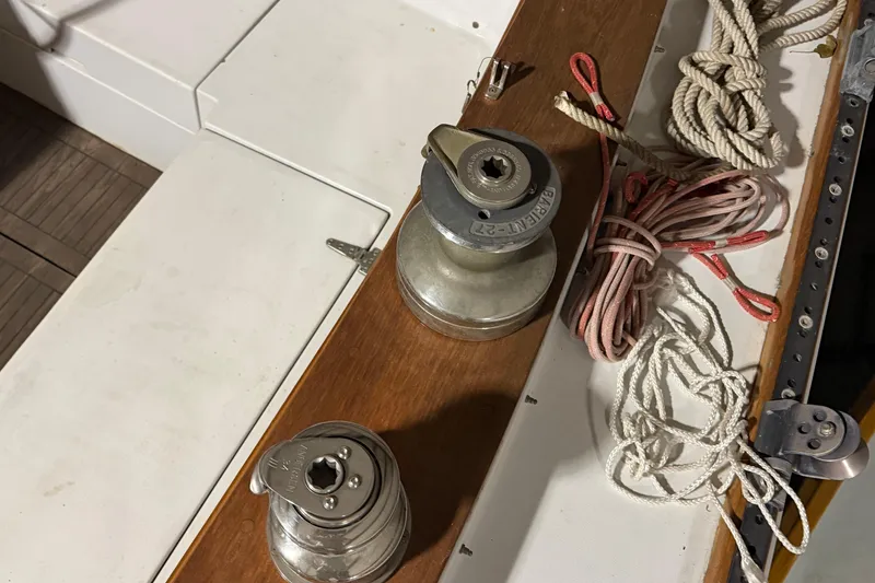 Slide: The Image of 1978 CSY 44 Center Cockpit sailboat deck with winches and coiled ropes. - 5