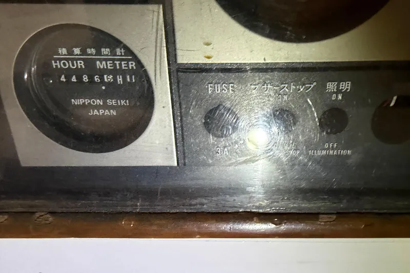 Slide: The Image of Close-up of a 1978 CSY 44 Center Cockpit hour meter and fuse panel. - 9