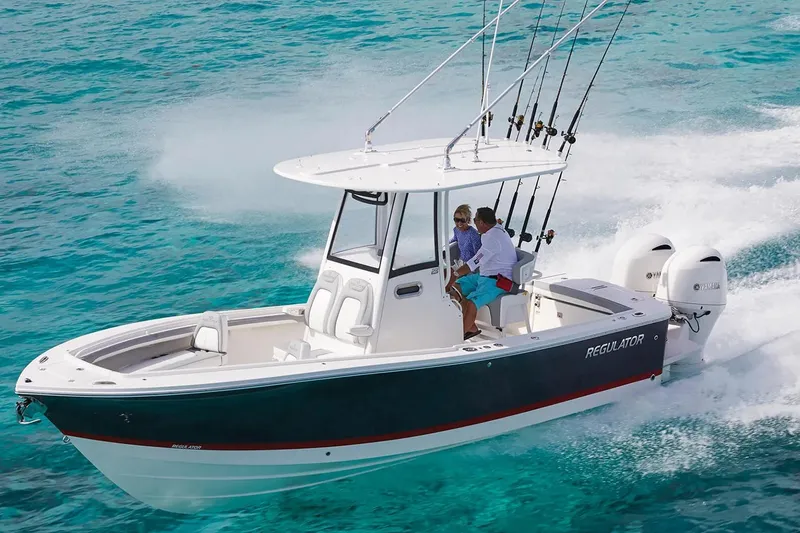 The Image of 2027 Regulator 23 boat cruising on clear turquoise water with fishing rods. - 0