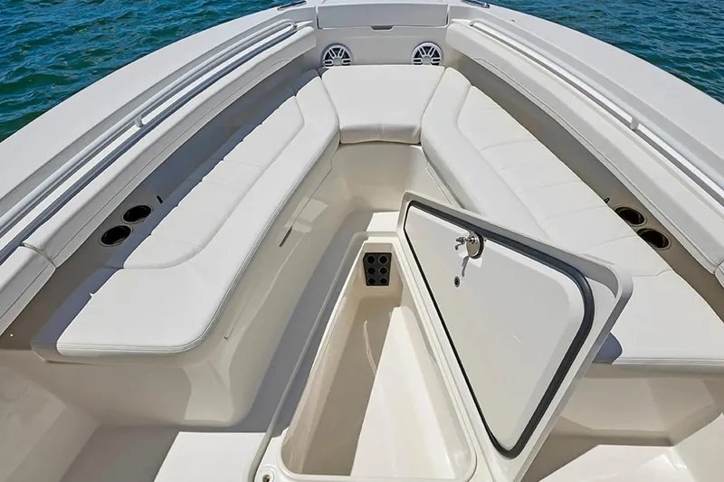 Slide: The Image of 2027 Regulator 23 boat interior with open storage compartment and cushioned seating. - 15