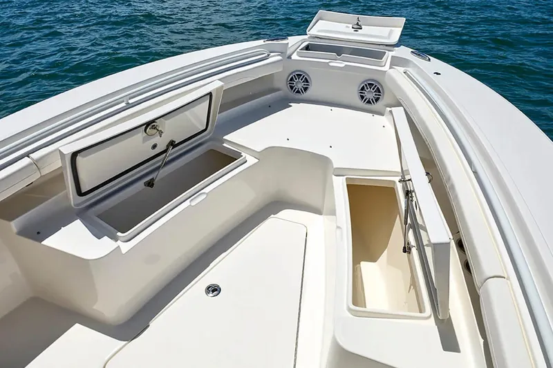 Slide: The Image of 2027 Regulator 23 boat interior with open storage compartments on calm water. - 16