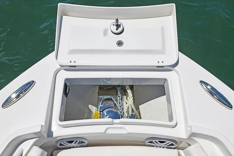 Slide: The Image of 2027 Regulator 23 boat anchor storage compartment with open lid, showcasing ropes and anchor. - 17