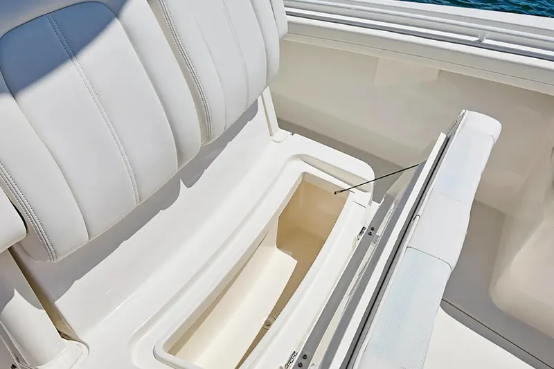 Slide: The Image of 2027 Regulator 23 boat with open storage compartment and white cushioned seating. - 19