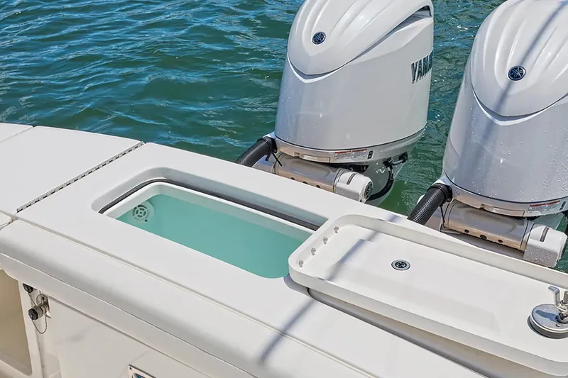 Slide: The Image of 2027 Regulator 23 boat with twin Yamaha engines and livewell on a sunny day. - 3