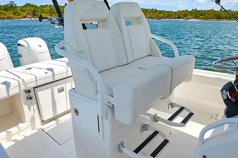 Slide: The Image of Luxury seating on 2027 Regulator 23 boat, featuring dual helm chairs and ocean backdrop. - 7