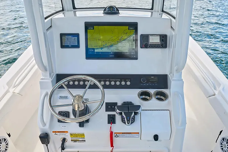 Slide: The Image of Helm of 2027 Regulator 23 boat with navigation screens and controls. - 8