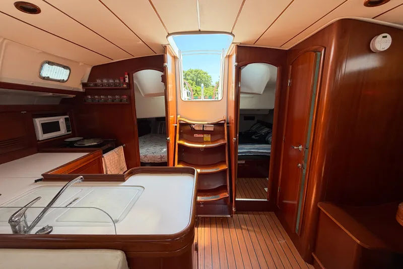 Slide: The Image of Interior of 2003 Beneteau Oceanis 473 yacht with wooden finish and modern amenities. - 10