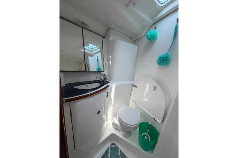 Slide: The Image of Bathroom of 2003 Beneteau Oceanis 473 yacht, featuring modern fixtures and teal accents. - 19