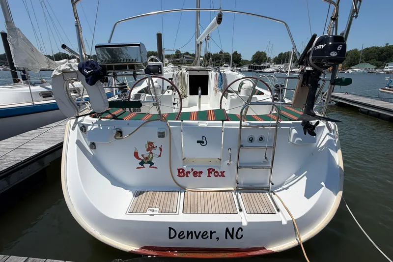 Slide: The Image of 2003 Beneteau Oceanis 473 sailboat docked, featuring "Br'er Fox" name and Denver, NC location. - 2