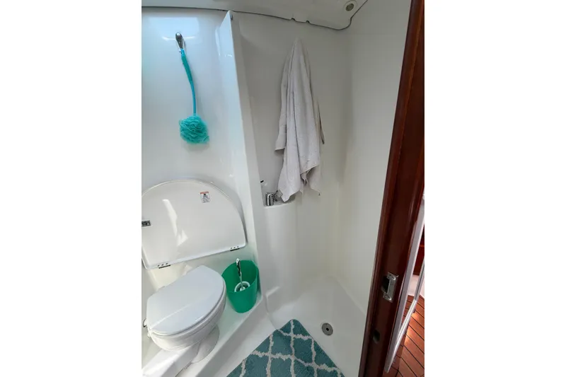 Slide: The Image of Bathroom interior of 2003 Beneteau Oceanis 473 yacht, featuring toilet and shower area. - 20