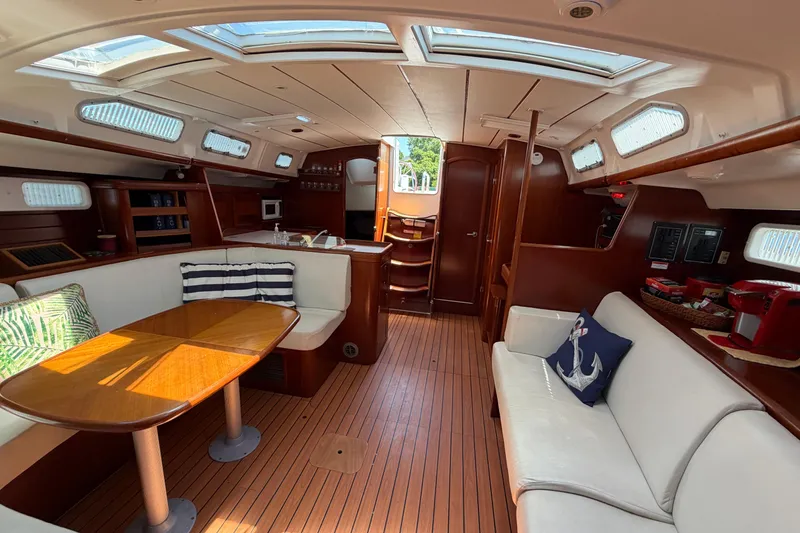 Slide: The Image of Interior of 2003 Beneteau Oceanis 473 yacht with elegant wood finish and cozy seating. - 22