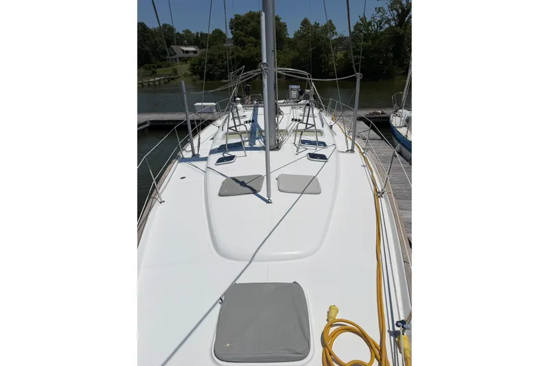 Slide: The Image of Deck view of a 2003 Beneteau Oceanis 473 sailboat docked at a marina. - 32