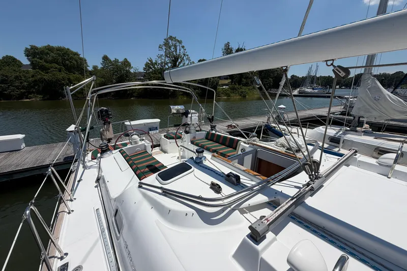 Slide: The Image of 2003 Beneteau Oceanis 473 sailboat docked, featuring spacious deck and cockpit area. - 33