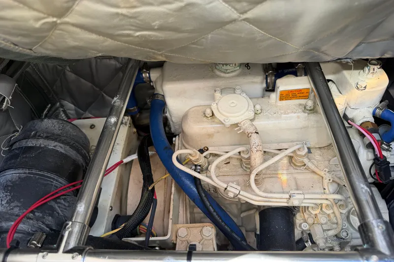 Slide: The Image of Engine compartment of a 2003 Beneteau Oceanis 473 sailboat, showcasing mechanical components. - 34