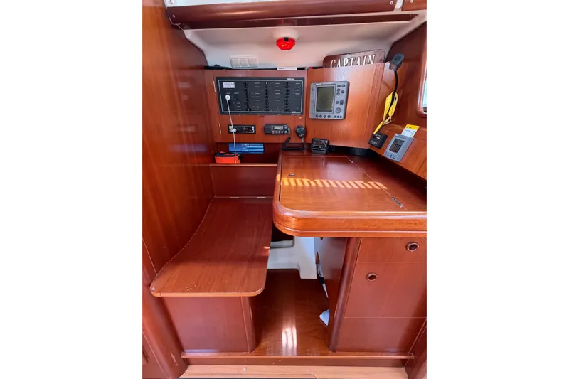 Slide: The Image of Navigation station on 2003 Beneteau Oceanis 473 yacht with wooden interior and control panels. - 7