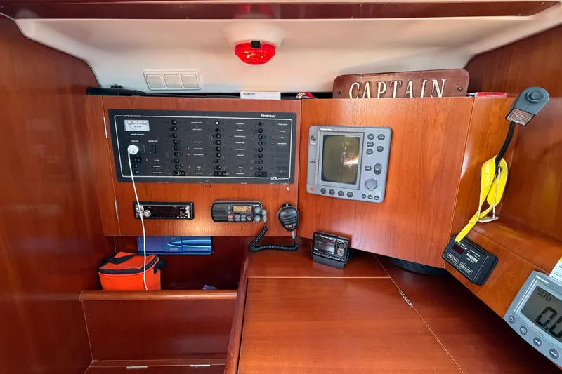 Slide: The Image of Navigation station of 2003 Beneteau Oceanis 473 yacht with control panels and equipment. - 8