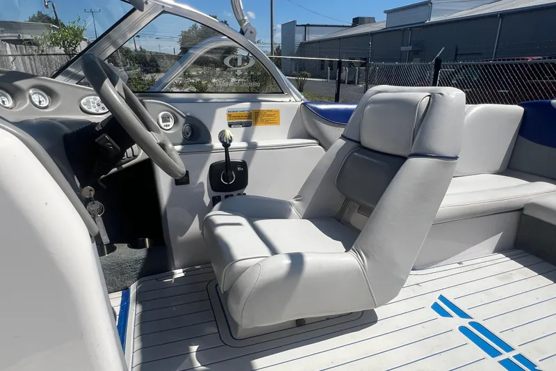 Slide: The Image of 2002 Moomba Mobius LSV boat interior with steering wheel and seating. - 10