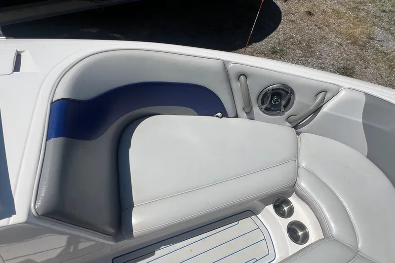 Slide: The Image of 2002 Moomba Mobius LSV boat interior with gray and blue seating and speaker. - 14