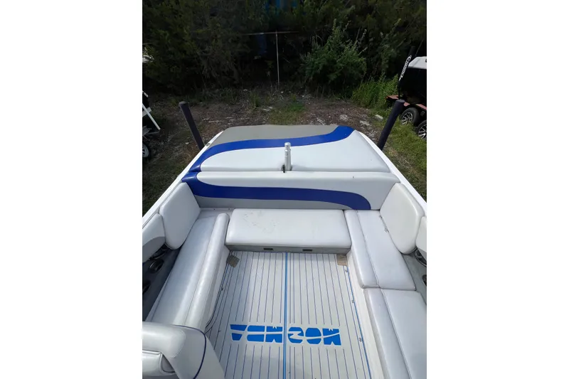 Slide: The Image of 2002 Moomba Mobius LSV boat interior with white and blue seating, outdoor setting. - 5