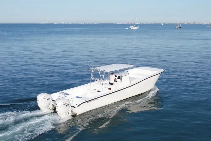Slide: The Image of 2025 AmeraCat 39 boat cruising on calm blue waters with twin Yamaha engines. - 1