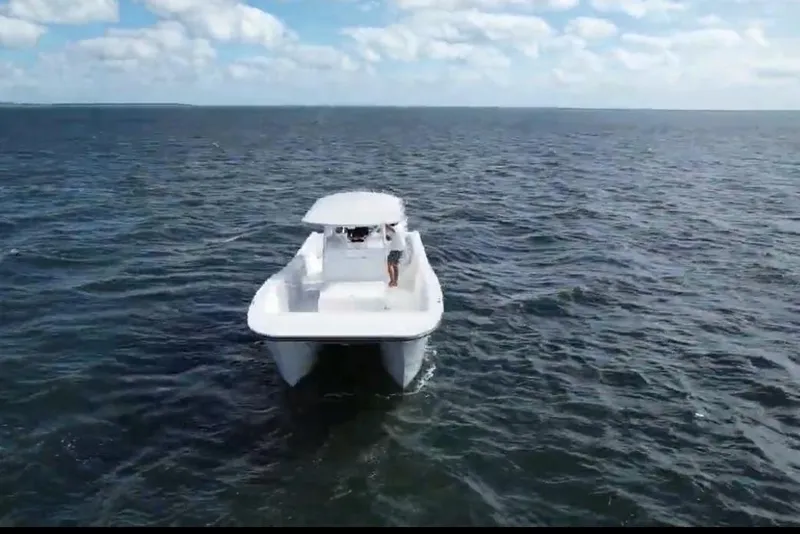 Slide: The Image of 2025 AmeraCat 39 boat cruising on open water under a partly cloudy sky. - 11