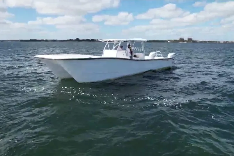 Slide: The Image of 2025 AmeraCat 39 boat cruising on open water under a partly cloudy sky. - 13