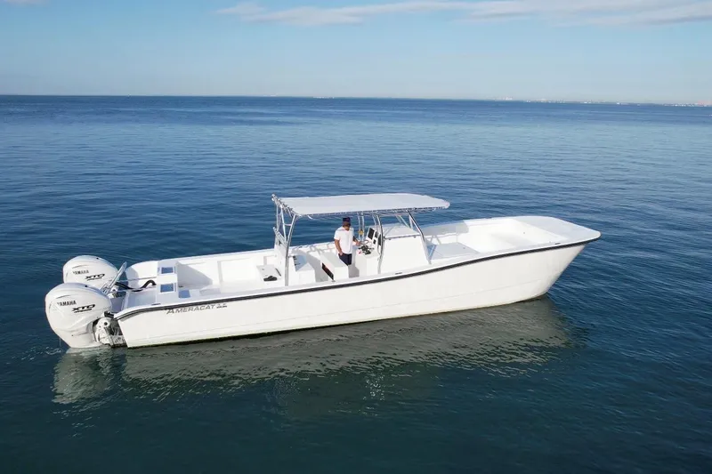 Slide: The Image of 2025 AmeraCat 39 boat on calm ocean waters, featuring dual Yamaha engines. - 2