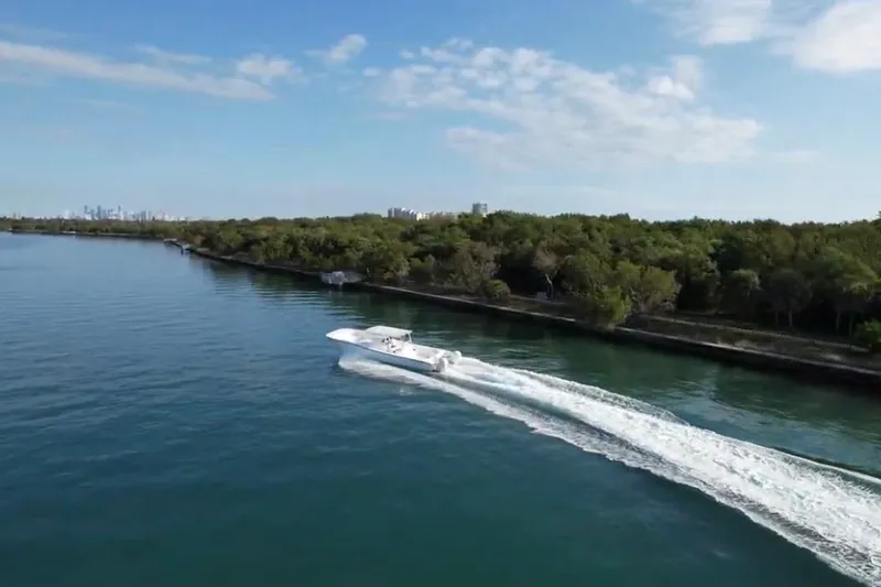 Slide: The Image of Aerial view of 2025 AmeraCat 39 boat cruising along a scenic coastline. - 16