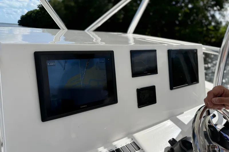 Slide: The Image of 2025 AmeraCat 39 boat dashboard with navigation screens and steering wheel. - 5