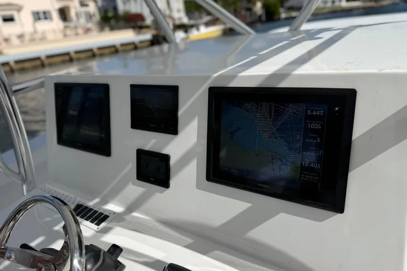 Slide: The Image of Helm of 2025 AmeraCat 39 boat featuring advanced navigation displays and controls. - 6