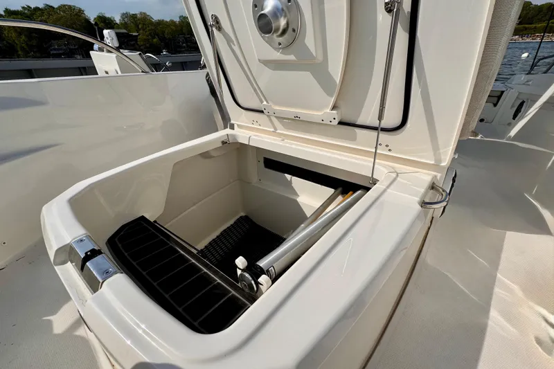 Slide: The Image of Open storage compartment on 2022 Boston Whaler 220 Dauntless boat, showcasing interior features. - 8