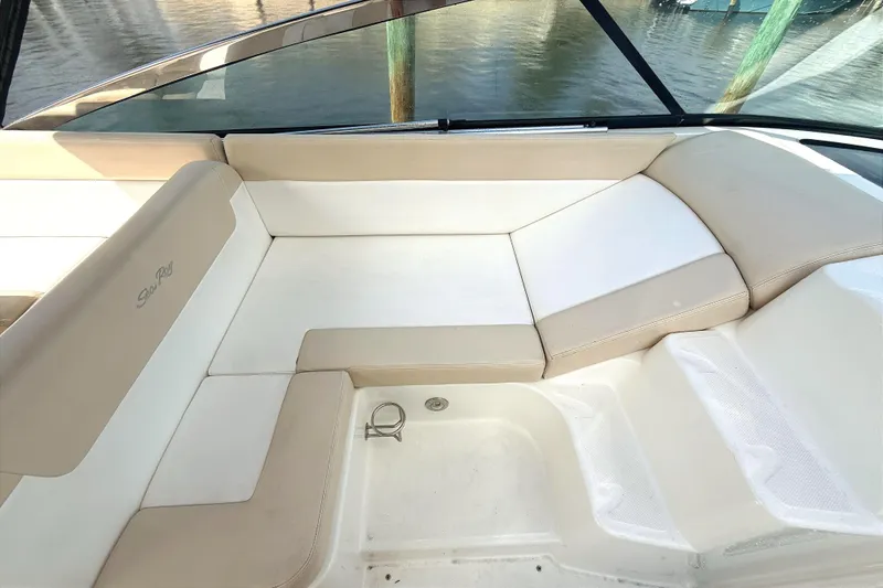 Slide: The Image of 2013 Sea Ray 370 Venture boat interior with beige seating and water view. - 11