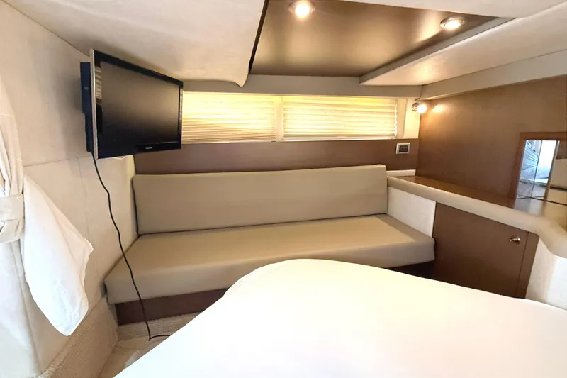 Slide: The Image of Interior of 2013 Sea Ray 370 Venture yacht with sofa, TV, and modern lighting. - 19
