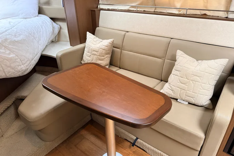 Slide: The Image of Interior of 2013 Sea Ray Sundancer 350 with beige seating and wooden table. - 15