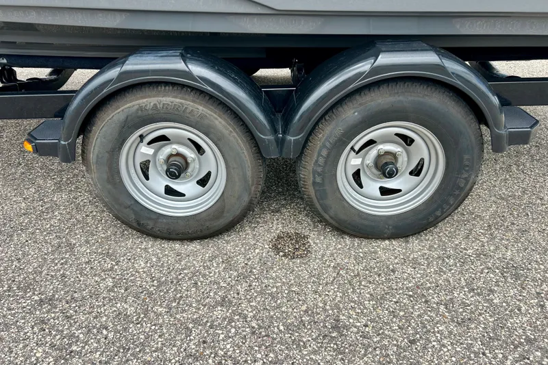 Slide: The Image of Trailer wheels of a 2015 Yamaha Boats AR210 on asphalt surface. - 17