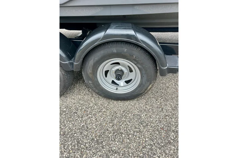 Slide: The Image of Trailer wheel of a 2015 Yamaha Boats AR210 on asphalt surface. - 20
