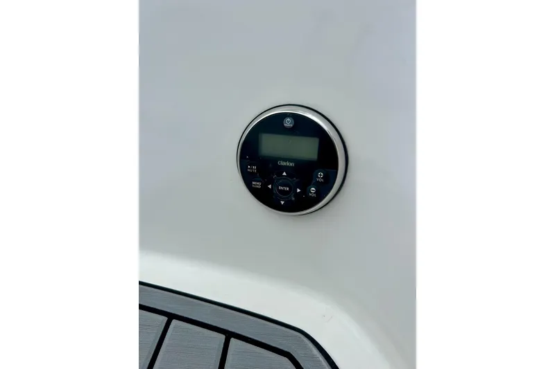 Slide: The Image of Control panel on 2015 Yamaha AR210 boat, featuring Clarion audio system. - 22